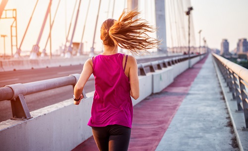 Hoya Vision sports lenses woman running on bridge